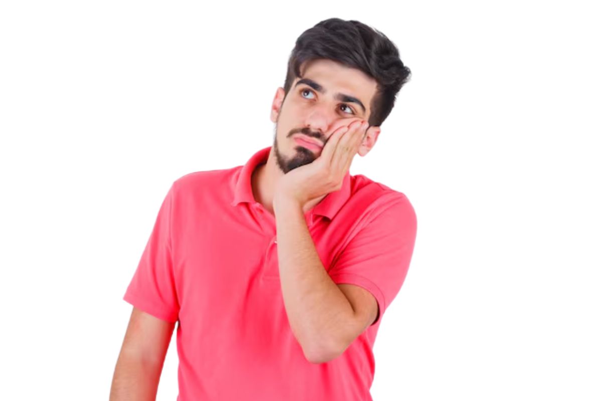 Patient gently biting on gauze after tooth extraction to control bleeding
